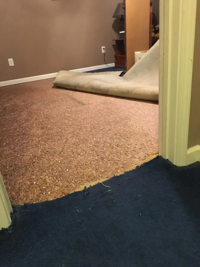 Carpet pad removal revealing water damage during Water Mitigation Services in Pike Creek Valley